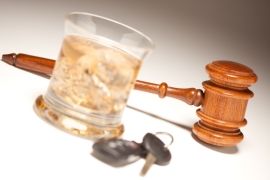 Glass of alcohol, car keys, and gavel